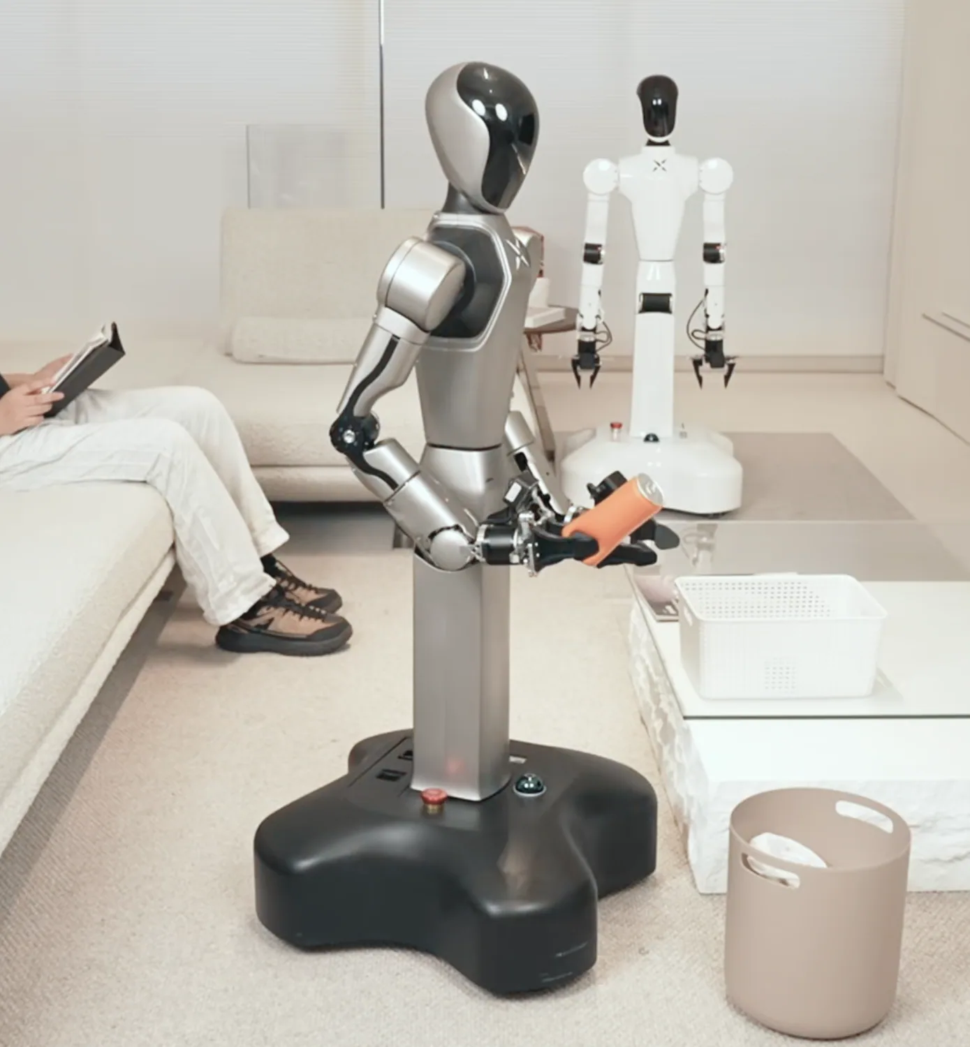 HUMANOID ROBOT delivering an object in a living-room setting.